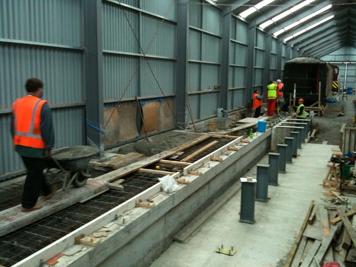 Ray wheeling through another load of concrete to the floor area and pit wall