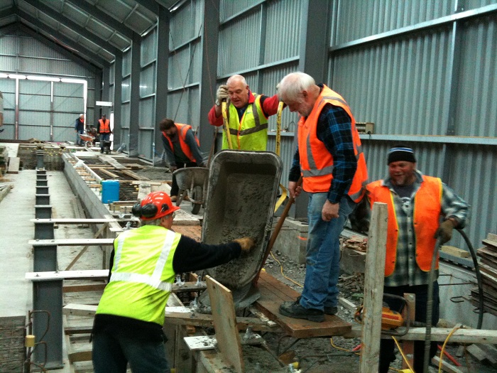 Placing concrete into pit wall formwork