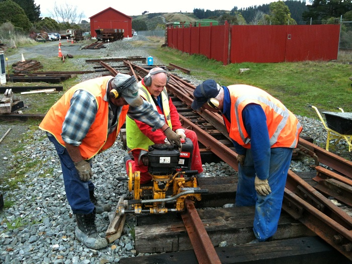 Colin, Peter and John drilling fish-bolt holes in checkrail