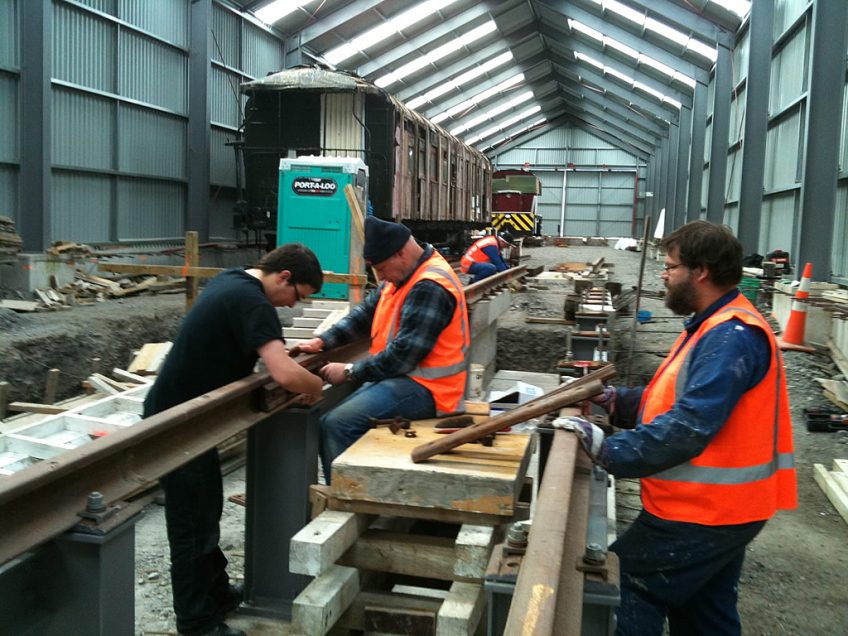 Steve, Ben and Ray bolting up a freshly installed running rail on the road 2 pit on 14 August 2011.