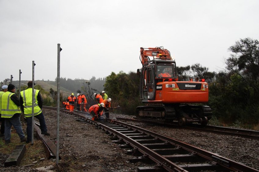 KiwiRail track gang work to slew the Wairarapa line rails to couple to the temporary siding at Maymorn. Photo: Doug Johnston