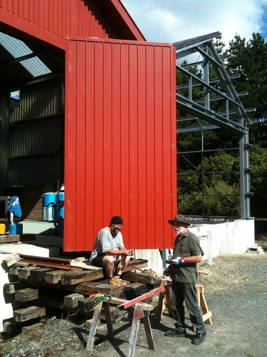 And the day before - volunteers take a break from fitting flashings to train doors on the rail vehicle shed