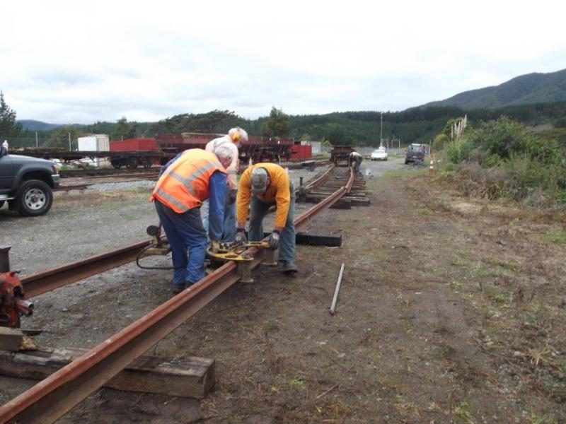 John, Colin and Steve crowing rail to correct radius. Photo: Glenn Fitzgerald
