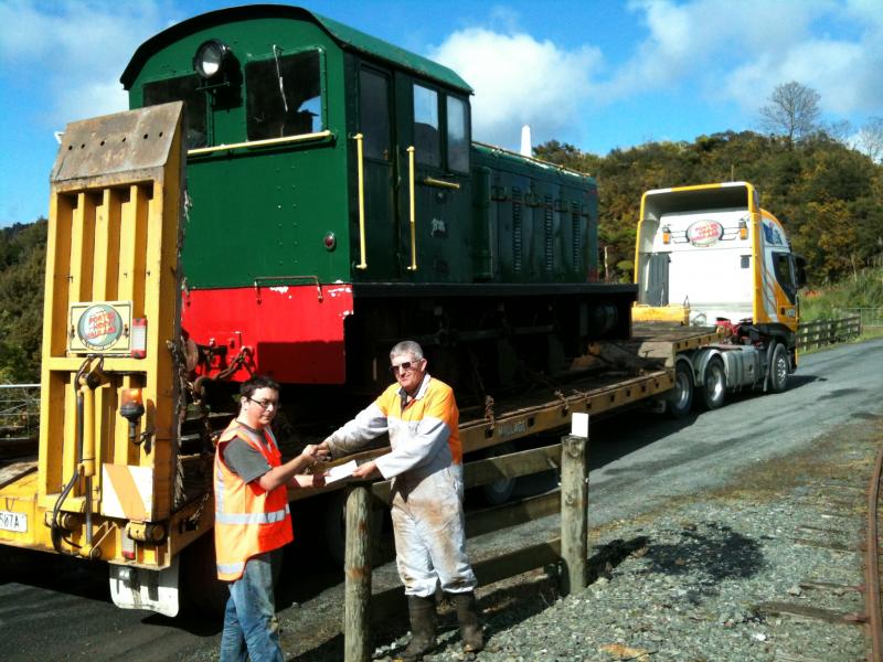 Official handover of the locomotive once safely loaded onto the truck - Trust Chairperson Ben Calcott hands cheque to Bruce McLuckie.
