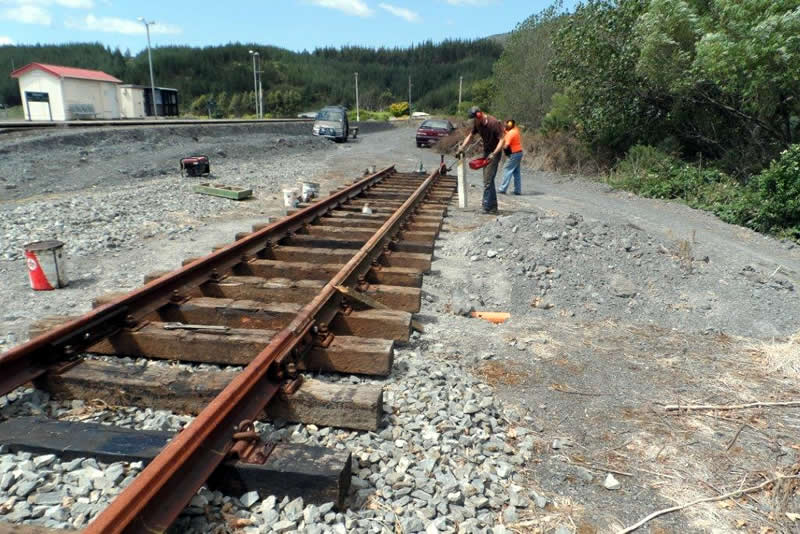 Mainline track being constructed past gate
