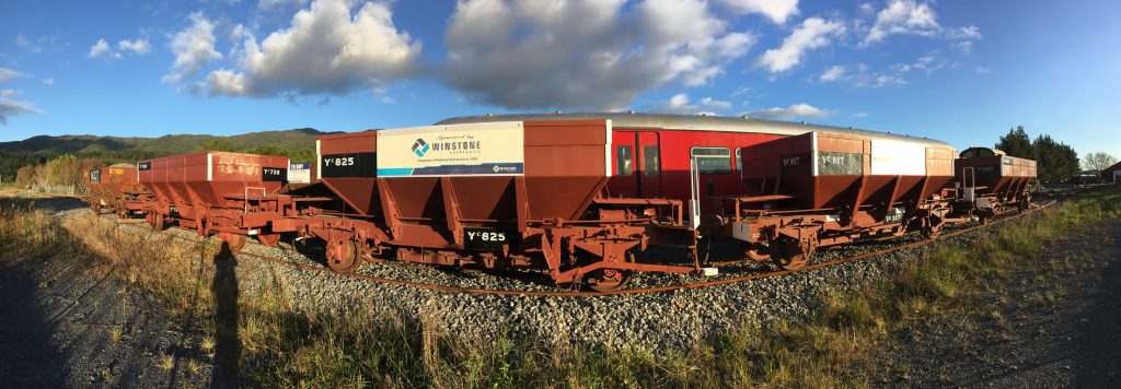 Panorama shot of rake of ballast wagons parked at Maymorn station