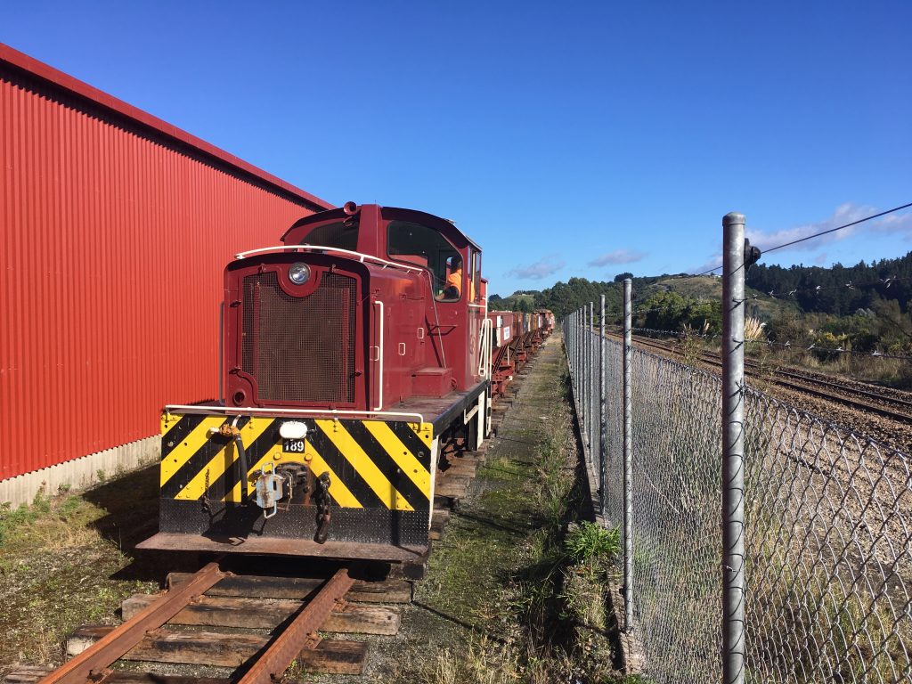 Diesel locomotive Tr 189 shunting ballast wagons down the turntable road on 23 April 2022