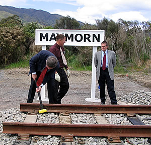 Hon. Paul Swain installs clip in first length of track of the Rimutaka Incline Railway. 