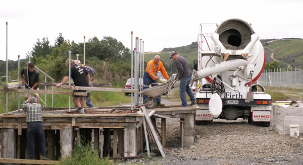 Team place concrete for pedestrian crossing. 