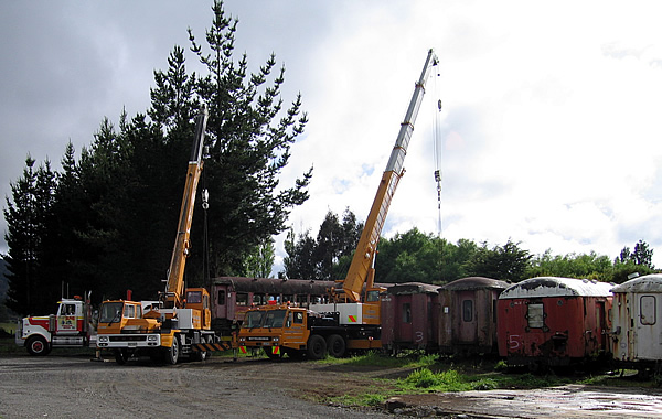 Cranes lifting carriage onto truck at Ohakune.