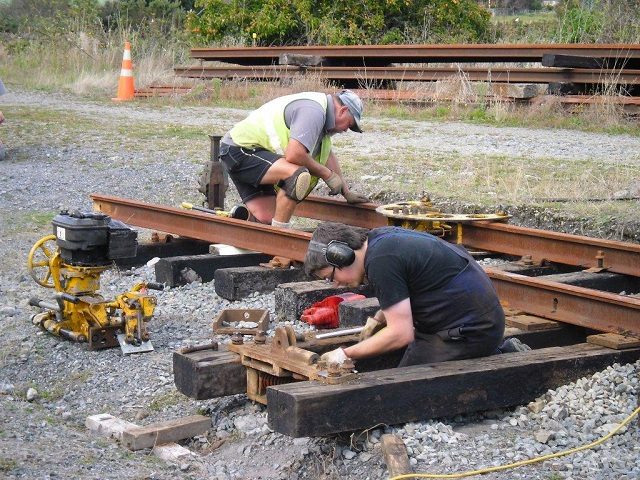 Ben working on the Wynn Williams mechanism, Colin crowing the running rails ahead of the switches.