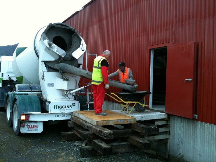 Higgins concrete truck delivering concrete at the side door of the rail vehicle shed, 18 August.