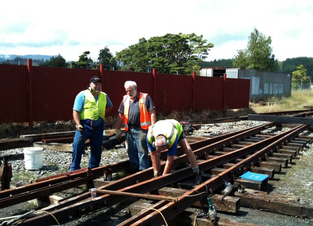 Mike, Steve and Peter fastening down rails between frog and heel of the road 2 turnout on 22 December 2012.