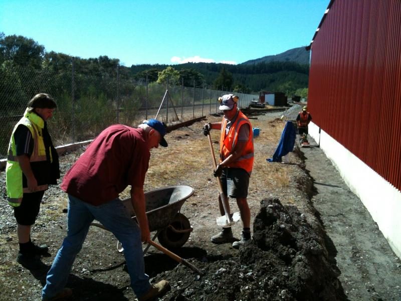 Iain, Lionel, John and Ray placing and compacting fill into rail vehicle shed foundations