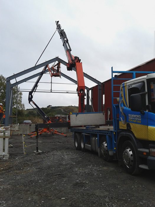 Hammond Crane and Transport truck, lifting the second portal into position. A cherrypicker gave access to install DHS purlins to couple the two portals. All purlins and girts were fitted by the end of the day. Photo: Ben Calcott