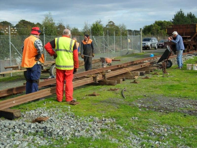 Colin and Peter straightening 50kg rail, whilst Hugh and John position sleepers, Lionel adding ballast to first set.