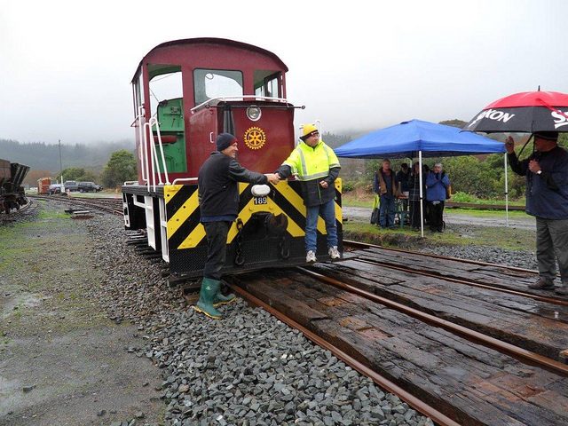 Kevin Joyce, right, and Hugh McCracken, left, celebrate unveiling of Rotary International badge affixed to shunting locomotive Tr 189. Photo: Glenn Fitzgerald.