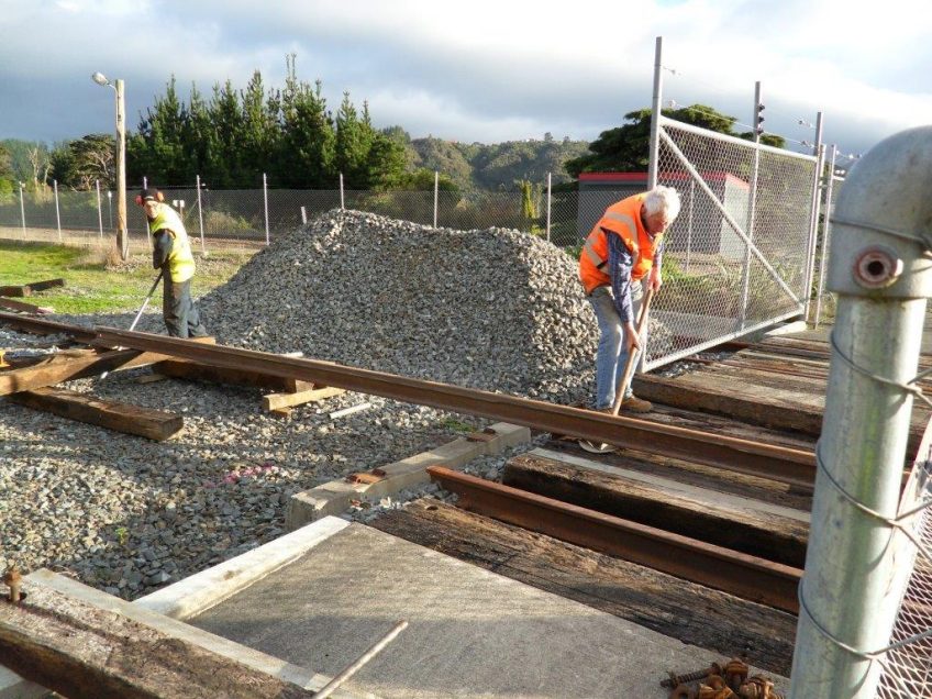 Hugh and Lionel manouvre rail into position through the pedestrian crossing