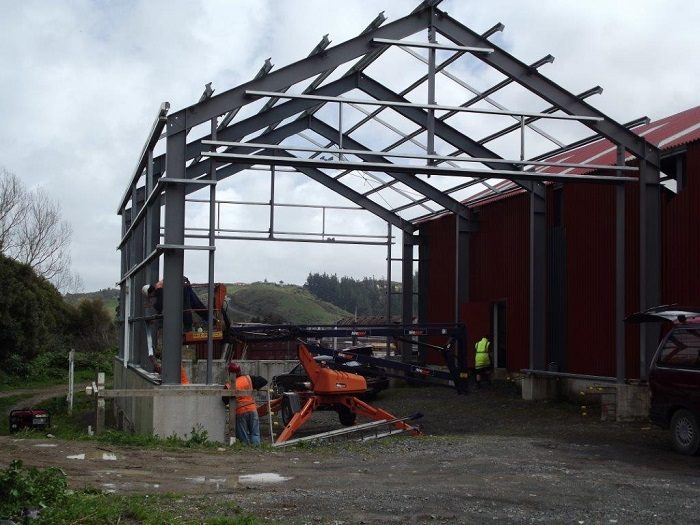 Later in the day - all purlins installed, brace channel being fitted mid-span.