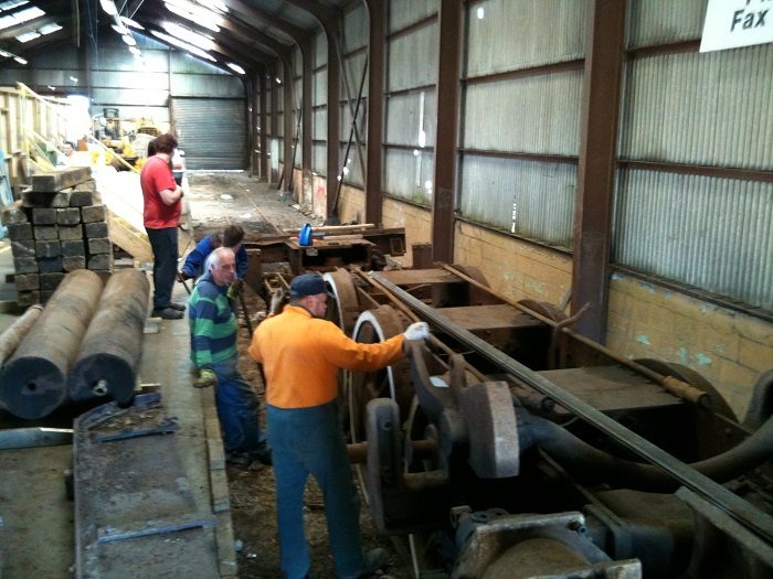Trust volunteers checking the frame inside the goods shed before the move