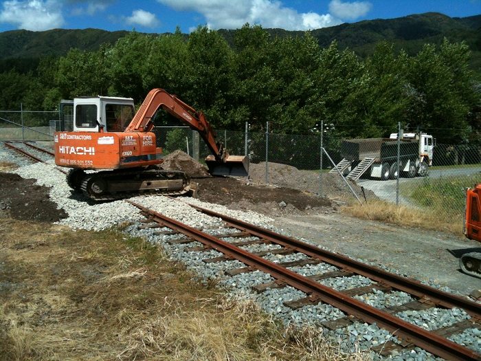 Forming landing pad of hard fill to south of crossing