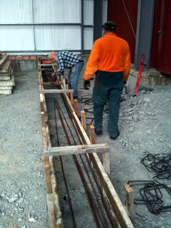 Another view of the rail beam, with straight reinforcing lengths and hoops being laid out.