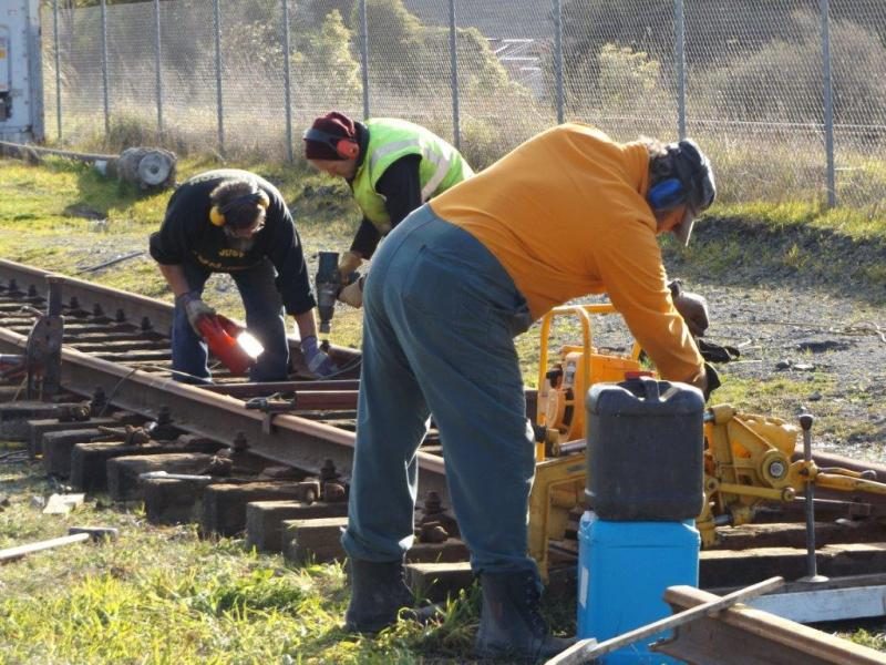 In the foreground - cutting 50kg rail to length, while in the background another trackset is assembled.