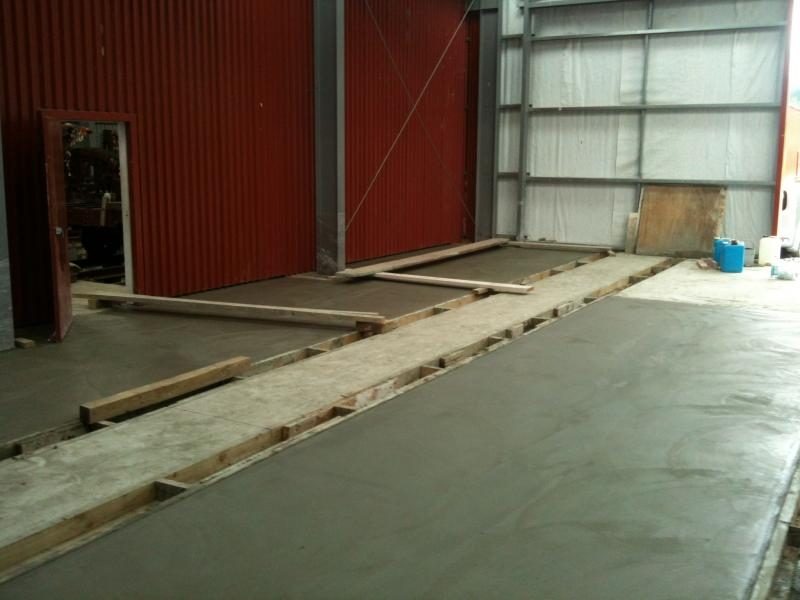 The workshop transformed with the completion of concrete floors.