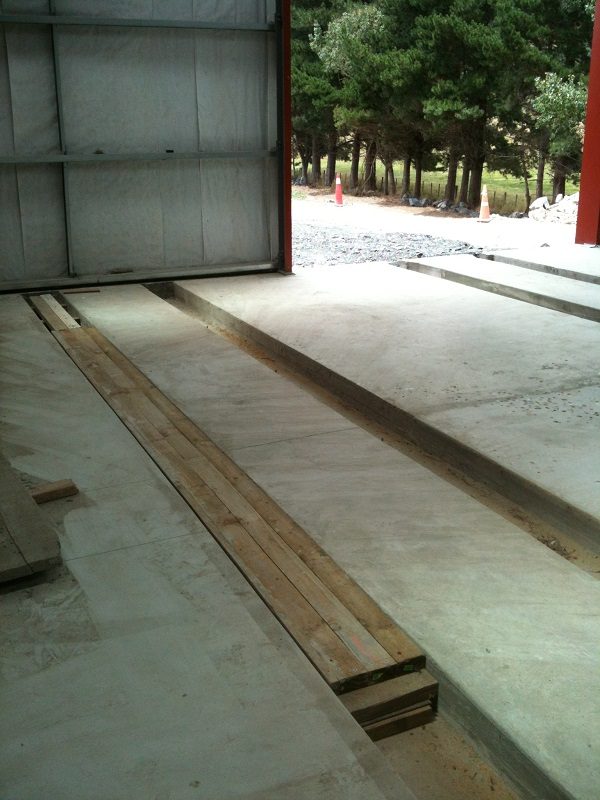 Timber flooring covering over road three rail channels in the workshop.