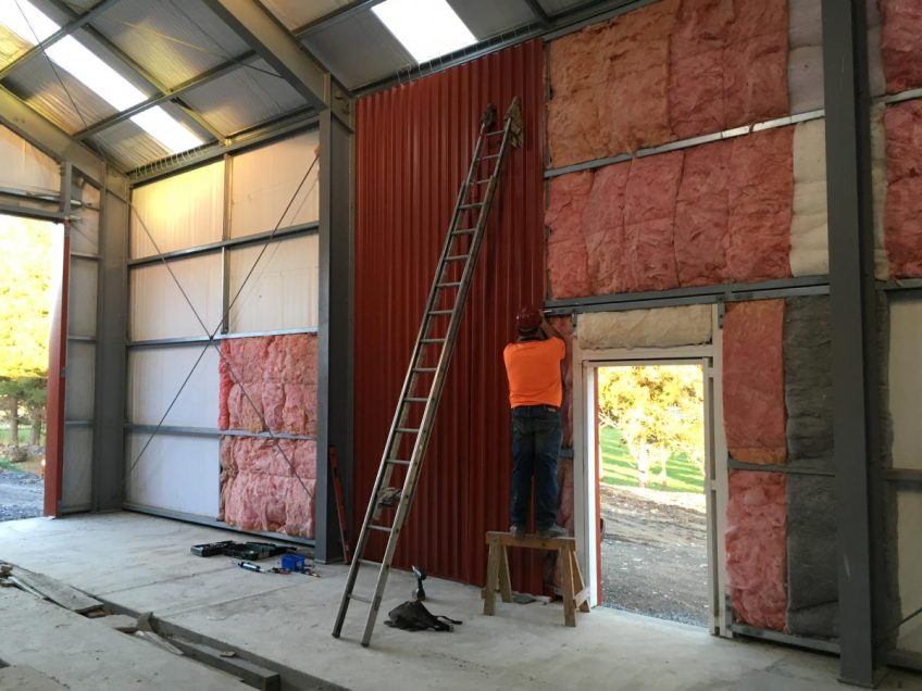 Ray fitting cladding to workshop wall