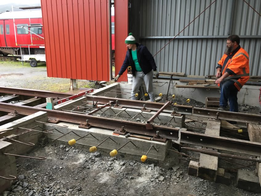 Ray and Glen back filling around rail beams on road 2