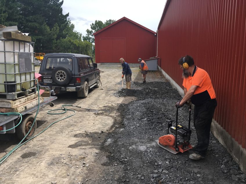 Backfilling foundations along the south side of the shed