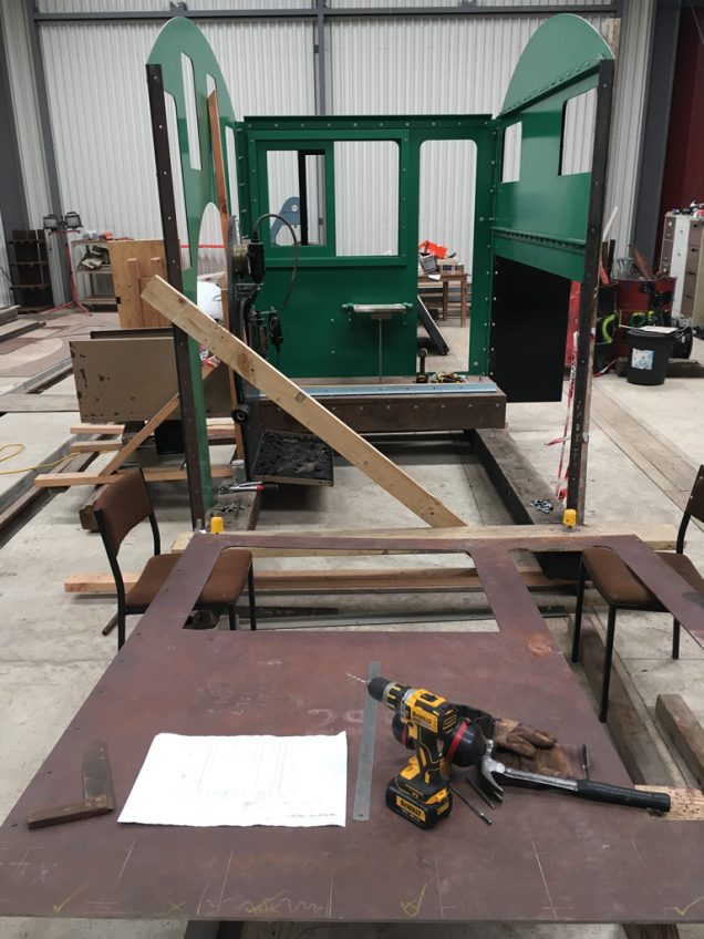 Fireman's cab side temporarily removed from the assembly locate steel angles at base and to carry the raised cab floor