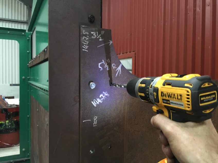 A close up of the bunker side, measurements in white marker pen and drilling pilot hole 