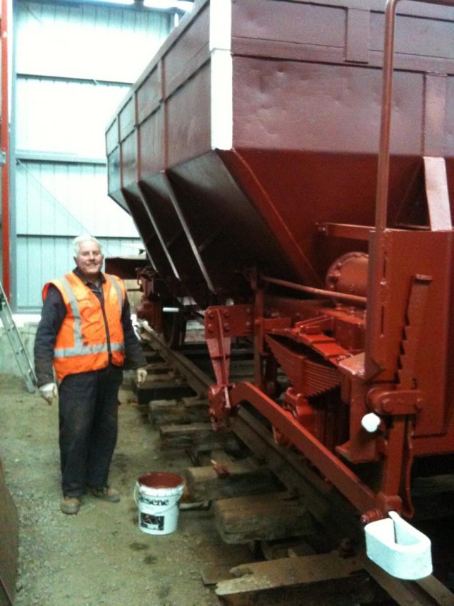 Ron Jones pauses for a photo while painting ballast wagon Yc 817