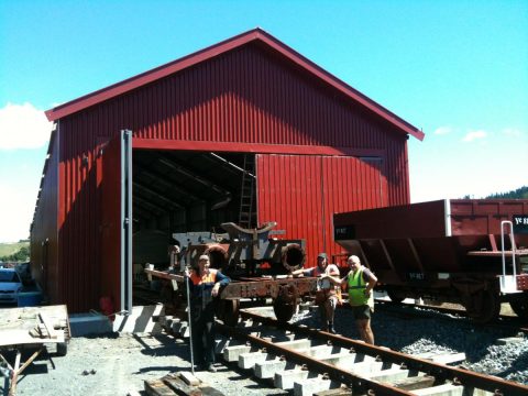 Hugh, John and Peter stand alongside the frames of Wb 299 during the move inside