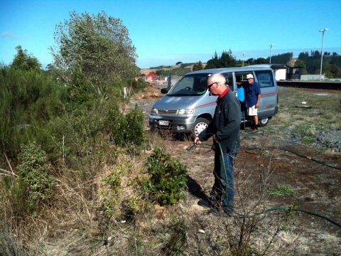 Bart and Graeme watering native shrubs planted at Maymorn